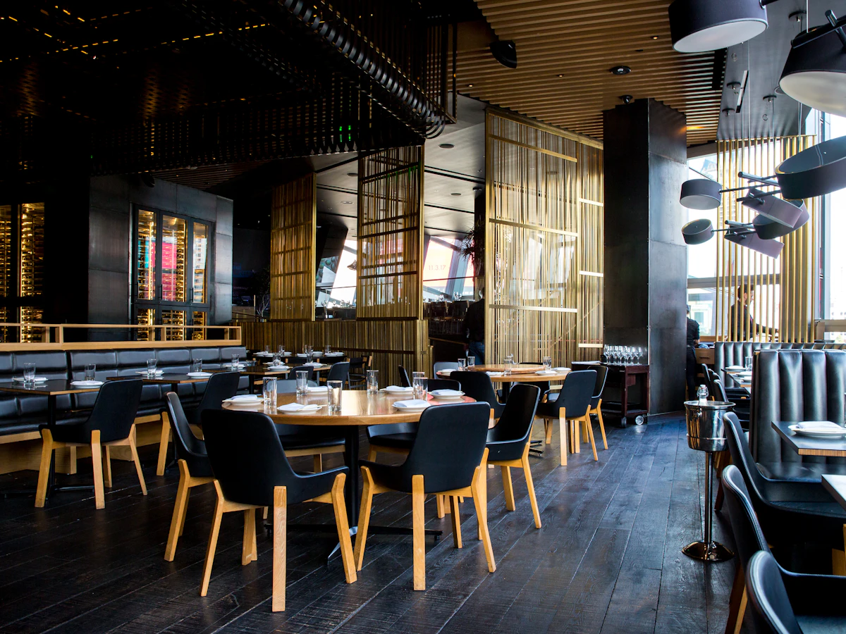 Inside an ARL Burger outlet: dark wood, brass and booth seating